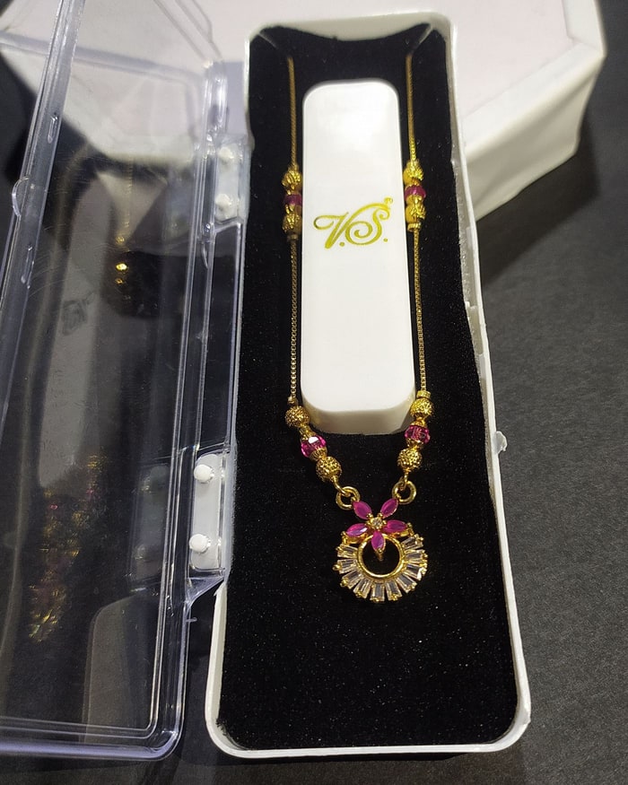Kairi Kemp Mangalsutra, Black-bead chain with a sunburst pendant and floral ruby drop