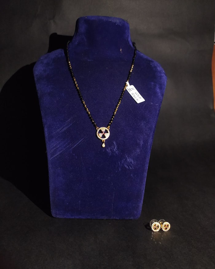 Nakshi Chakra Mangalsutra Set, Black-bead chain with a pinwheel pave pendant, ruby centre, matching studs