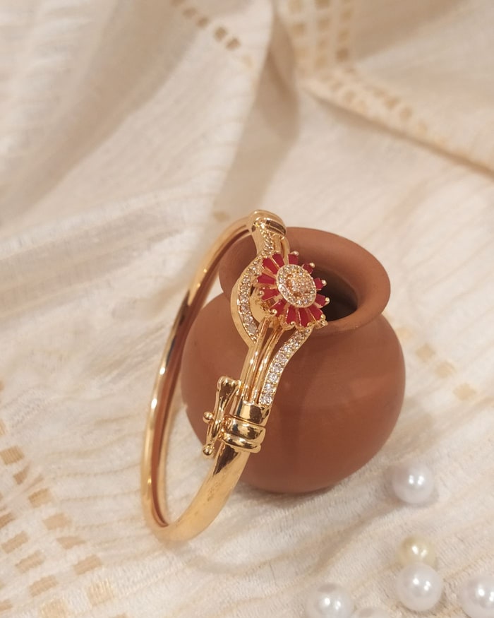 Kemp Surya Bracelet, Bypass-style bracelet with a ruby and CZ sunburst medallion