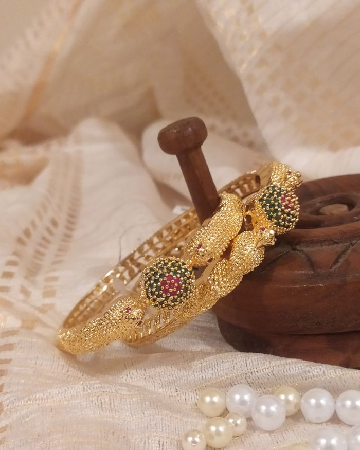 Kemp Mor Kada, Antique twisted-rope bangle pair, peacock-scale texture, ruby and green medallions