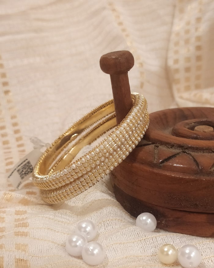 Moti Kemp Bangadi, Pearl-beaded bangle pair with rows of small ruby accents