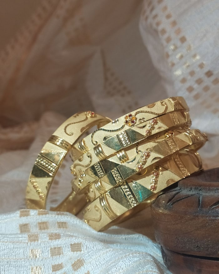 Nakshi Kada, Diamond-cut faceted bangle pair, scroll and floral engraving